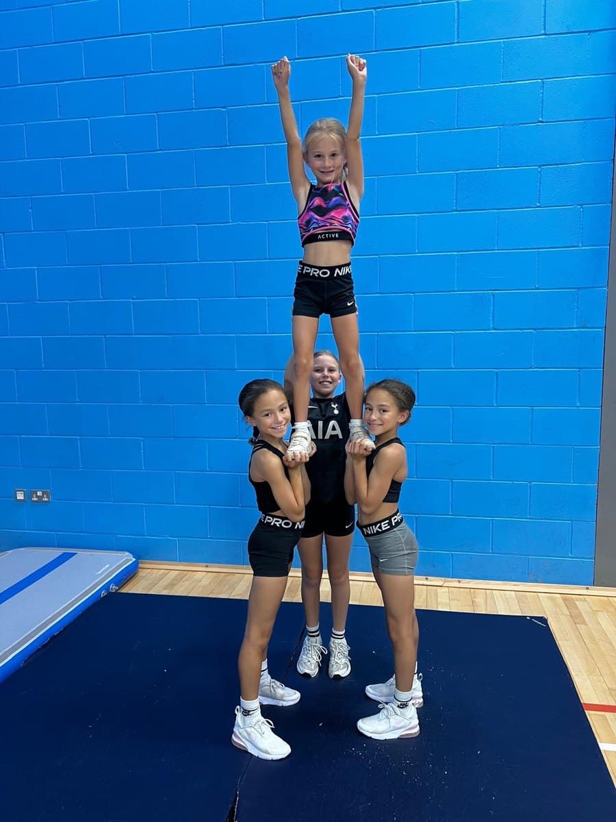 Pixies cheerleaders performing a group stunt